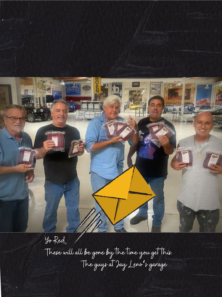 jay leno and his crew with lehrs summer sausage smokie snack sticks at Jay Leno's garage promoting our sausage