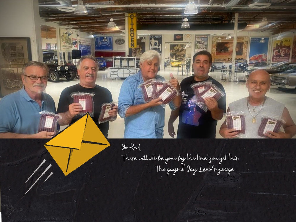 picture of jay leno and his crew with lehrs handcrafted smokie snack sticks at Jay Leno Garage